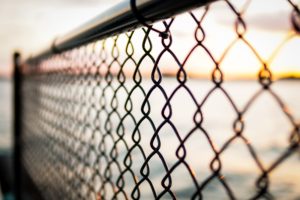 Chain link fence security safe and immigration metaphor